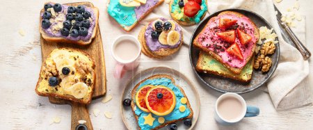 Photo for Sweet breakfast with cup of cocoa. Toast with cream cheese, banana, strawberries, blueberries. Top view, banner - Royalty Free Image