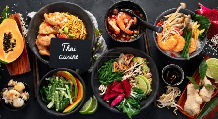 Photo for Assorted thai food set. Famous cuisine dishes on table on a dark background. Top view. Thai restaurant concept. - Royalty Free Image