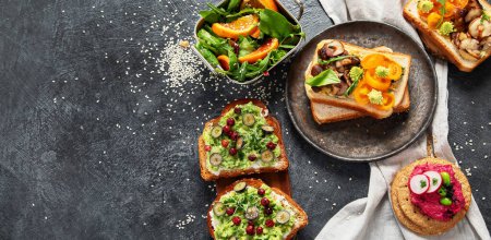 Photo for Vegan toast with avocado,mushroom and fresh salad on dark background. Vegetarian food concept. Top view, copy space, banner - Royalty Free Image
