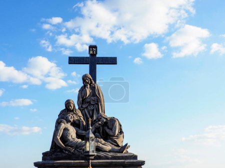 Prague, Czech Republic - May 10, 2024: Statuary of St. Cross , Calvary , in Charles Bridge