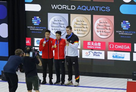 Photo for Berlin, Germany - March 24, 2024: Medalists of Men's 3m Springboard Final of World Aquatics Diving World Cup 2024: 1st - Zongyuan WANG (CHN), 2nd - Osmar OLVERA IBARRA (MEX), 3rd - Lars RUDIGER (GER) - Royalty Free Image