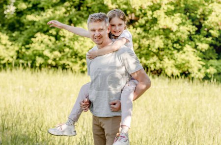 Photo for Happy dad holding smiling little daughter hugging - Royalty Free Image