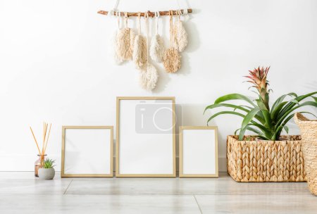 Photo for Wooden frame collection for photos plants and boho style decoration in scandinavian interior mockup. Minimal template with empty picture blank at home - Royalty Free Image