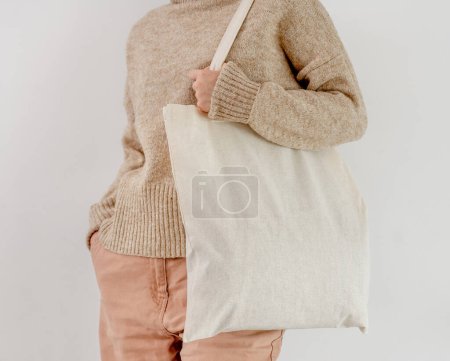 Foto de Girl holding cotton linen eco bag mockup. Woman with environment friendly shopping handbag with empty copy space for business - Imagen libre de derechos