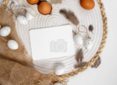 Photo for Easter mockup with traditional eggs, feathers and trendy sack decor on table. Festive spring holiday template with greetings postcards with copy space - Royalty Free Image