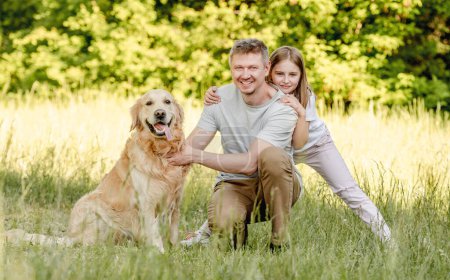 Photo for Dad and his daugter play with golden retriver dog - Royalty Free Image