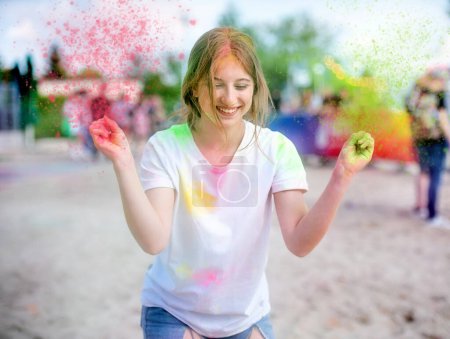 Photo for Pretty girls in indian traditional Holi festival with colorful powder having fun. Female teenager and preteen child enjoying positive holiday of India - Royalty Free Image