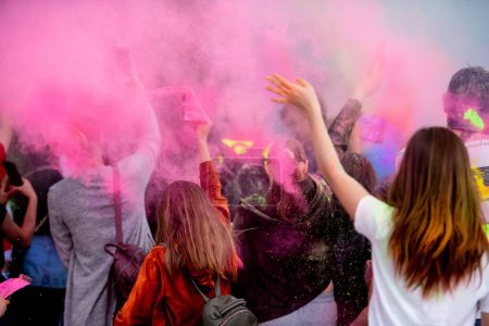 Photo for People with colorful powder during indian holiday Holi. Positive crowd having fun during hindu traditional festival - Royalty Free Image