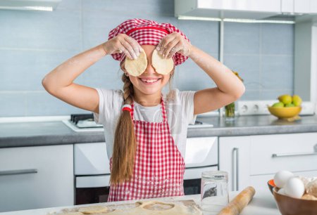 Photo for Cut little girl having fun with pieces of dough - Royalty Free Image
