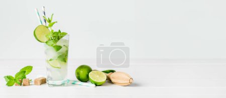 Photo for Non-alcoholic cocktail mojito with ingredients for its preparation on a white background - Royalty Free Image