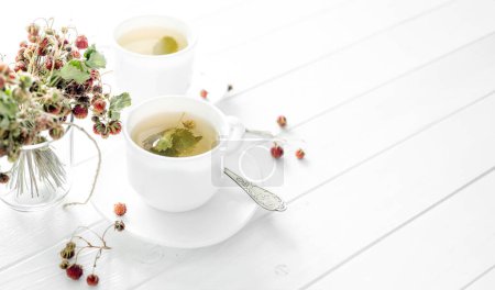 Photo for Two cups of strawberry tea on a wooden background - Royalty Free Image