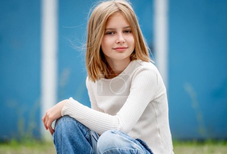 Photo for Cute preteen gitl with blond hair portrait. Pretty child kid model sitting and looking at camera - Royalty Free Image