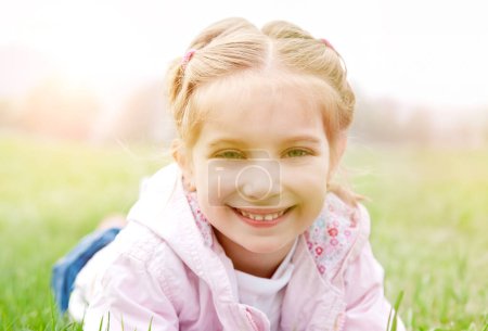 Photo for Cute little girl on the meadow in spring day - Royalty Free Image
