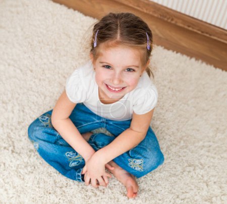 Photo for Cute little girl sitting on the floor. top view - Royalty Free Image