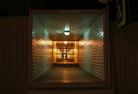 Photo for Long metal tunnel or passage in night - Royalty Free Image