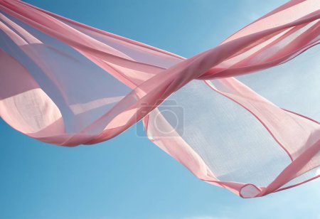 Téléchargez les photos : Onde de tissu rose volant sur fond bleu ciel et éclairée par la lumière du soleil, ondulant tissu flottant de soie - en image libre de droit