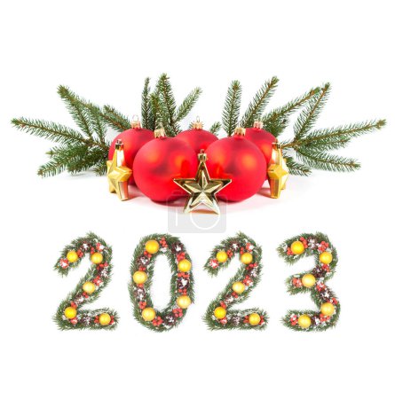 Photo for Red christmas ball and 2023 number made by christmas tree branches isolated on white background - Royalty Free Image