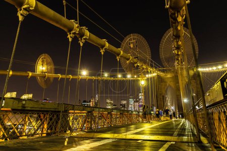 Photo for Brooklyn bridge pedestrian walkway at night in New York City, NY, USA - Royalty Free Image