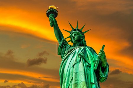 Photo for Statue of Liberty against sunset sky with beautiful cloud background in New York City, NY, USA - Royalty Free Image