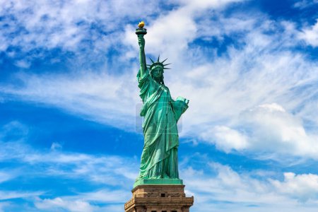 Photo for Statue of Liberty against blue sky with beautiful cloud background in New York City, NY, USA - Royalty Free Image
