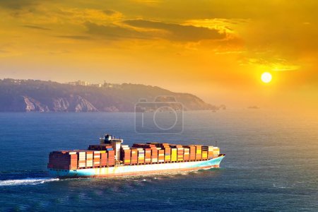 Container cargo ship in San Francisco Bay in San Francisco at sunset, California, USA