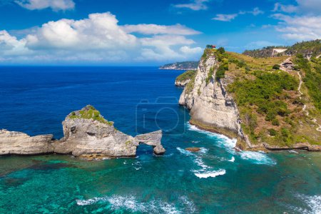 Photo for Natural Rock Arch in Ocean Water and Atuh Beach viewpoint in Nusa Penida island, Bali, Indonesia - Royalty Free Image