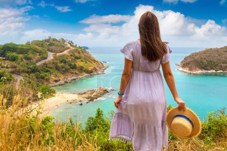 Photo for Woman traveler wearing blue dress and straw hat at   Panoramic view of  Yanui Beach at Phuket in Thailand in a summer day - Royalty Free Image