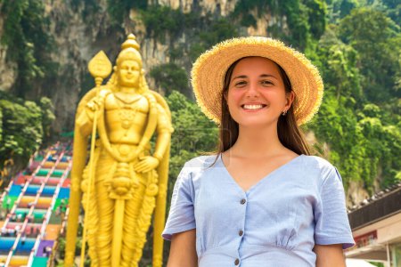 Photo for Woman traveler at  Batu cave, hinduism temple in a sunny day in Kuala Lumpur, Malaysia - Royalty Free Image