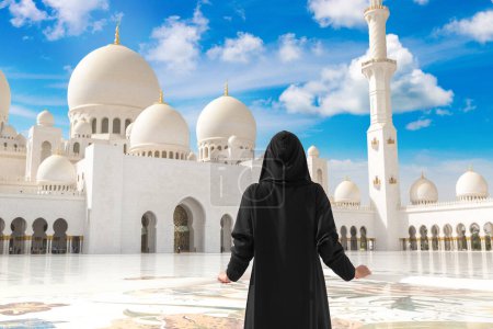 Photo for Beautiful woman is wearing arab clothes in Sheikh Zayed Grand Mosque in Abu Dhabi, United Arab Emirates - Royalty Free Image