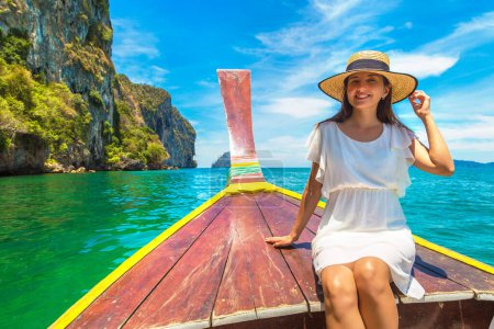 Photo for Happy traveler woman relaxing on boat near tropical island - Royalty Free Image
