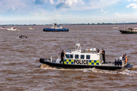 Photo for KINGSTON UPON HULL, UK - JUNE 2, 2022: Police boat watercraft patrols in Hull during the Queen's Platinum Jubilee, Kingston upon Hull, Yorkshire, UK - Royalty Free Image