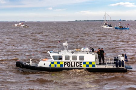Photo for KINGSTON UPON HULL, UK - JUNE 2, 2022: Police boat watercraft patrols in Hull during the Queen's Platinum Jubilee, Kingston upon Hull, Yorkshire, UK - Royalty Free Image