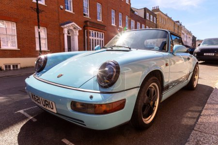 Photo for WINDSOR, UK - JUNE 19, 2022: Porsche 911 Carrera 4 Cabriolet in Blue in a sunny day in Windsor, UK - Royalty Free Image