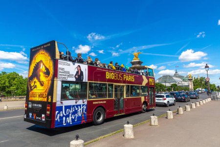 Photo for PARIS, FRANCE - JUNE 01, 2022: Hop-on Hop-Off BIGBUS sightseeing tourist bus on the Bridge Pont Alexandre III in Paris in a summer day, France - Royalty Free Image