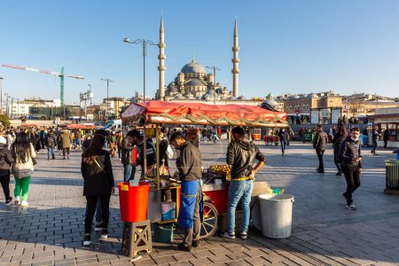 Photo for ISTANBUL, TURKEY - APRIL 10, 2022: Street turkish vendor sells traditional turkish hot grilled corn in Istanbul, Turkey in a sunny day - Royalty Free Image