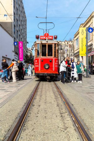 Photo for ISTANBUL, TURKEY - APRIL 10, 2022: Retro tram on Taksim Istiklal street in Istanbul, Turkey in a sunny day - Royalty Free Image