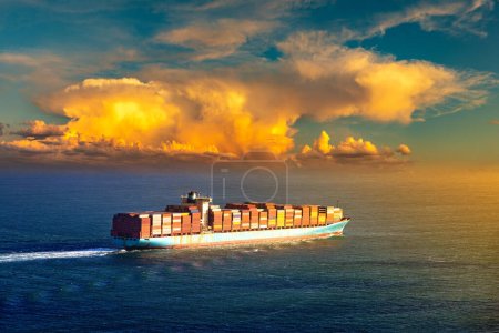 Téléchargez les photos : Conteneur cargo sur fond de ciel couchant dans l'océan - en image libre de droit