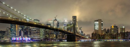 Photo for Panorama of  Brooklyn Bridge and panoramic night view of downtown Manhattan after sunset in New York City, USA - Royalty Free Image