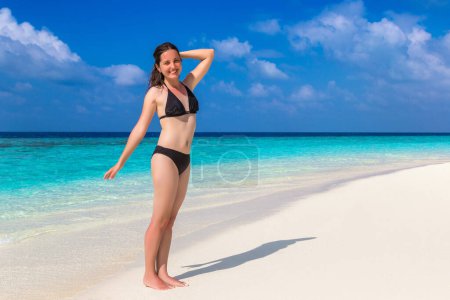 Photo for Sexy beautiful woman at luxury tropical beach in a sunny summer day - Royalty Free Image