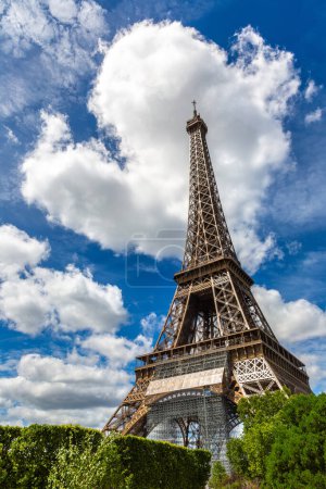 Photo for Eiffel Tower and Beautiful romantic cloud in heart shape in Paris in a sunny summer day, France - Royalty Free Image