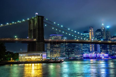 Photo for Brooklyn Bridge and panoramic night view of downtown Manhattan after sunset in New York City, USA - Royalty Free Image