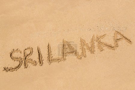 Téléchargez les photos : Mot Sri Lanka écrit dans un sable sur une plage tropicale au Sri Lanka - en image libre de droit