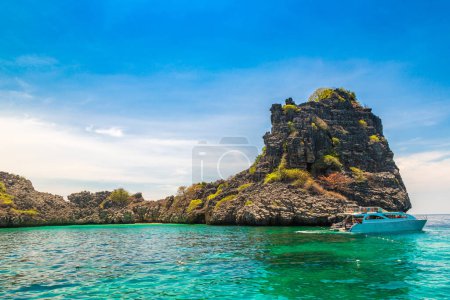 Photo for Speed boat and tourists snorkeling in a tropical sea near Koh Haa Islands, Thailand - Royalty Free Image