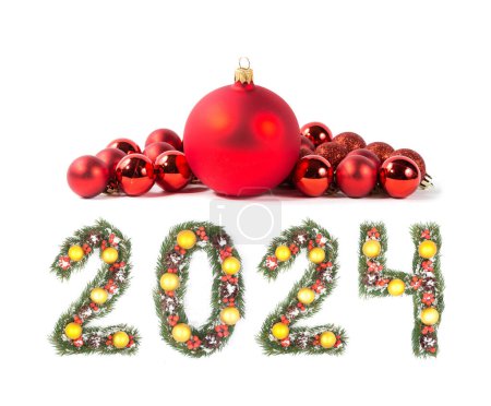 Photo for Red christmas ball and 2024 number made by christmas tree branches isolated on white background - Royalty Free Image