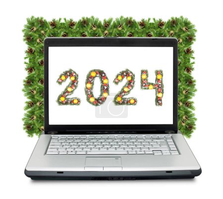 Photo for Christmas laptop and 2024 number made by christmas tree branches isolated on white background - Royalty Free Image