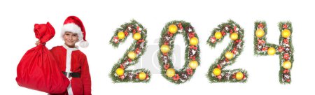 Photo for Boy Santa Claus holding a christmas sack and 2024 number made by christmas tree branches isolated on white background - Royalty Free Image