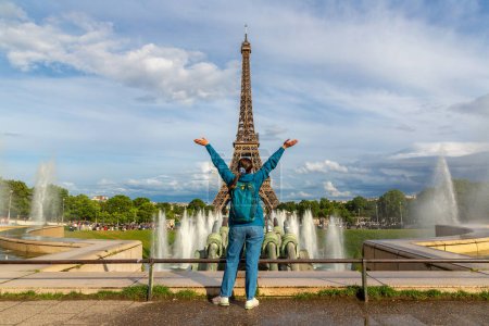 Photo for Woman traveler at Eiffel Tower and fountains of Trocadero in Paris at sunset, France - Royalty Free Image