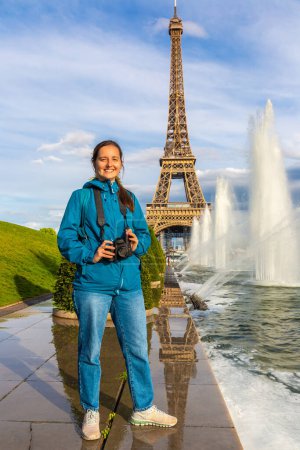 Photo for Woman traveler at Eiffel Tower and fountains of Trocadero in Paris at sunset, France - Royalty Free Image