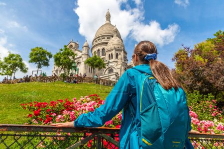Photo for Woman traveler at Basilica of the Sacred Heart at Montmartre hill in Paris (Basilica of Sacre Coeur) in a summer day, France - Royalty Free Image