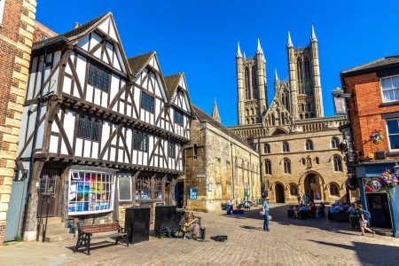 Photo for LINCOLN, UK - SEPTEMBER 5, 2023: Lincoln Cathedral and Medieval Tudor half-timbered house in a beautiful sunny day in Lincoln, United Kingdom - Royalty Free Image